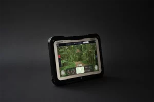 Autonomous navigation interface on rugged tablet showing UGV camera feeds and real-time terrain data