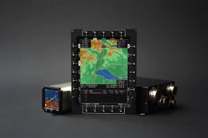 Mission computer alongside EFIS and ESIS instruments displaying flight data