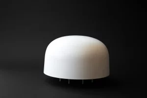White hemispherical multiband antenna VA56 for train radio system on dark background