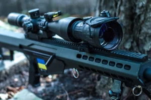Clip-on night vision device mounted on a precision rifle for enhanced low-light targeting