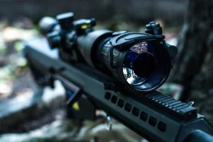 Close-up of night vision lens mounted on tactical rifle for night operations