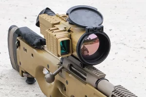 Close-up of TSA-7 thermal imaging riflescope mounted on bolt-action rifle, lens cover open