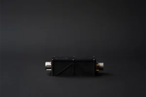 Compact UAV autopilot viewed from the side, showing dual interface connectors