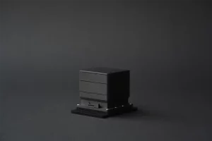 Side-angle view of AMODIS vibration sensor in black casing on studio background